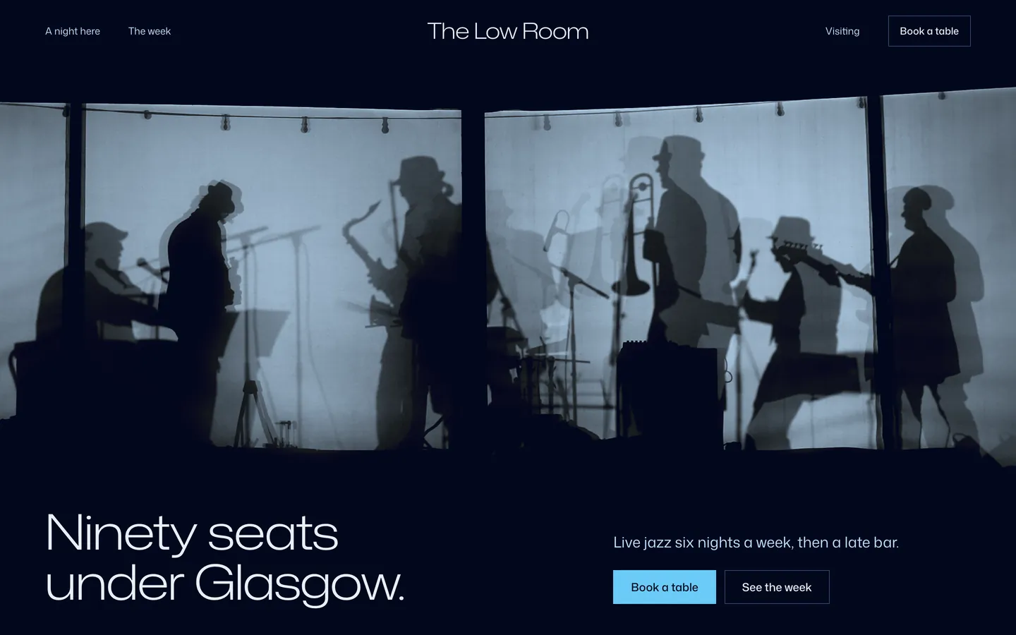 The Low Room: musicians in silhouette behind a screen over the headline Ninety seats under Glasgow.