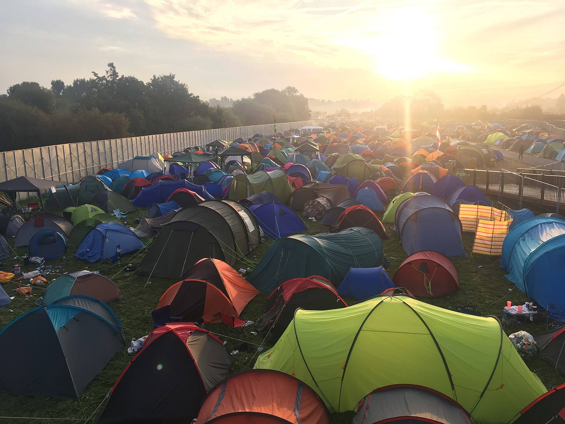 Sunrise over a festival campsite packed with tents