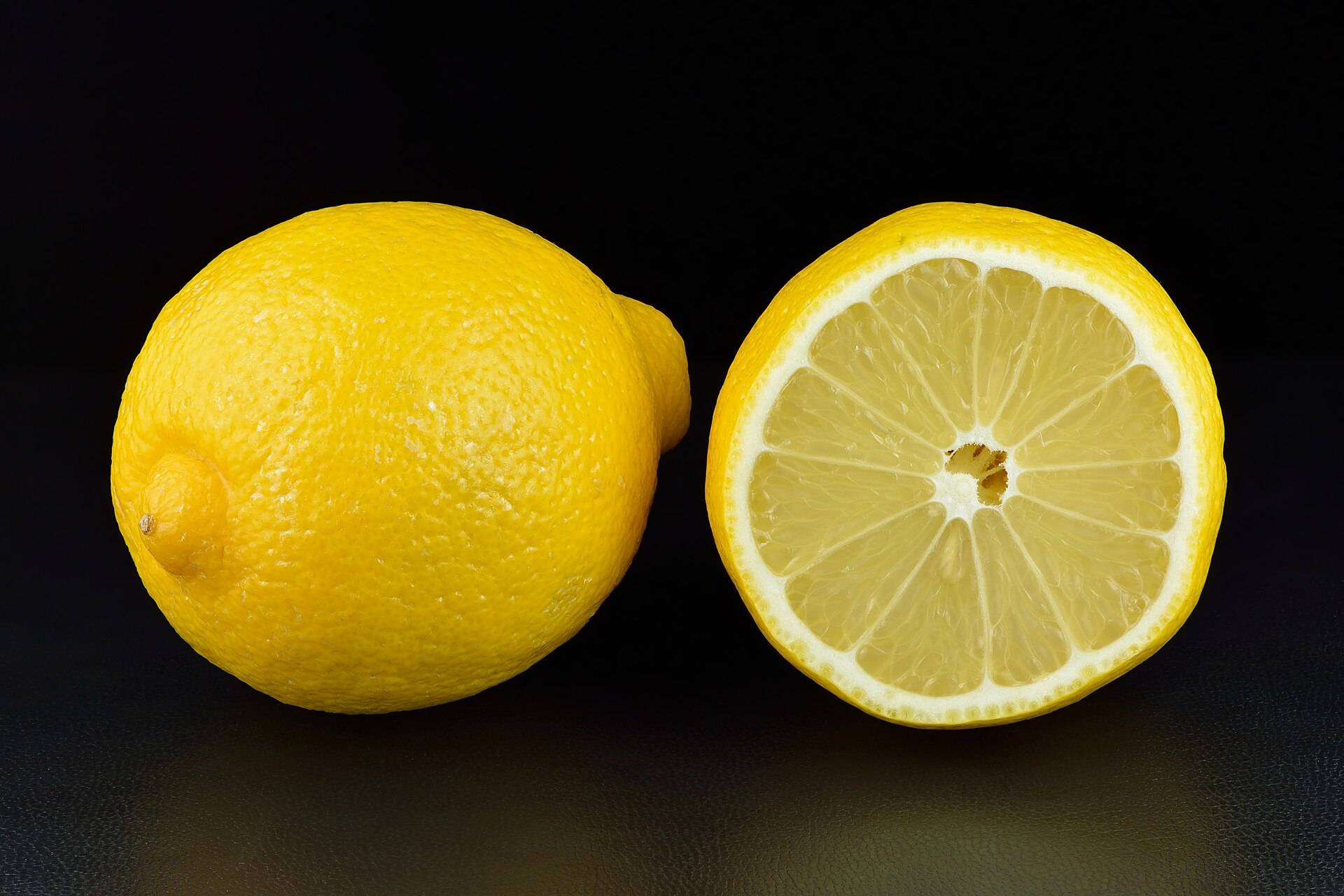 A lemon cut in half, its pale segments facing the light
