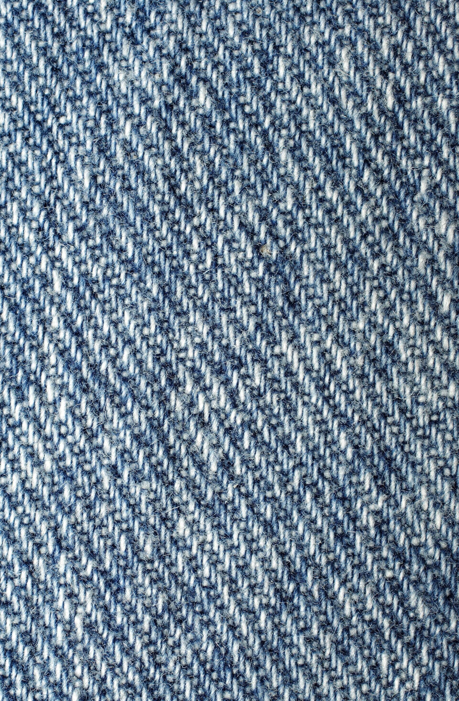 An indigo and white twill weave, close, filling the frame