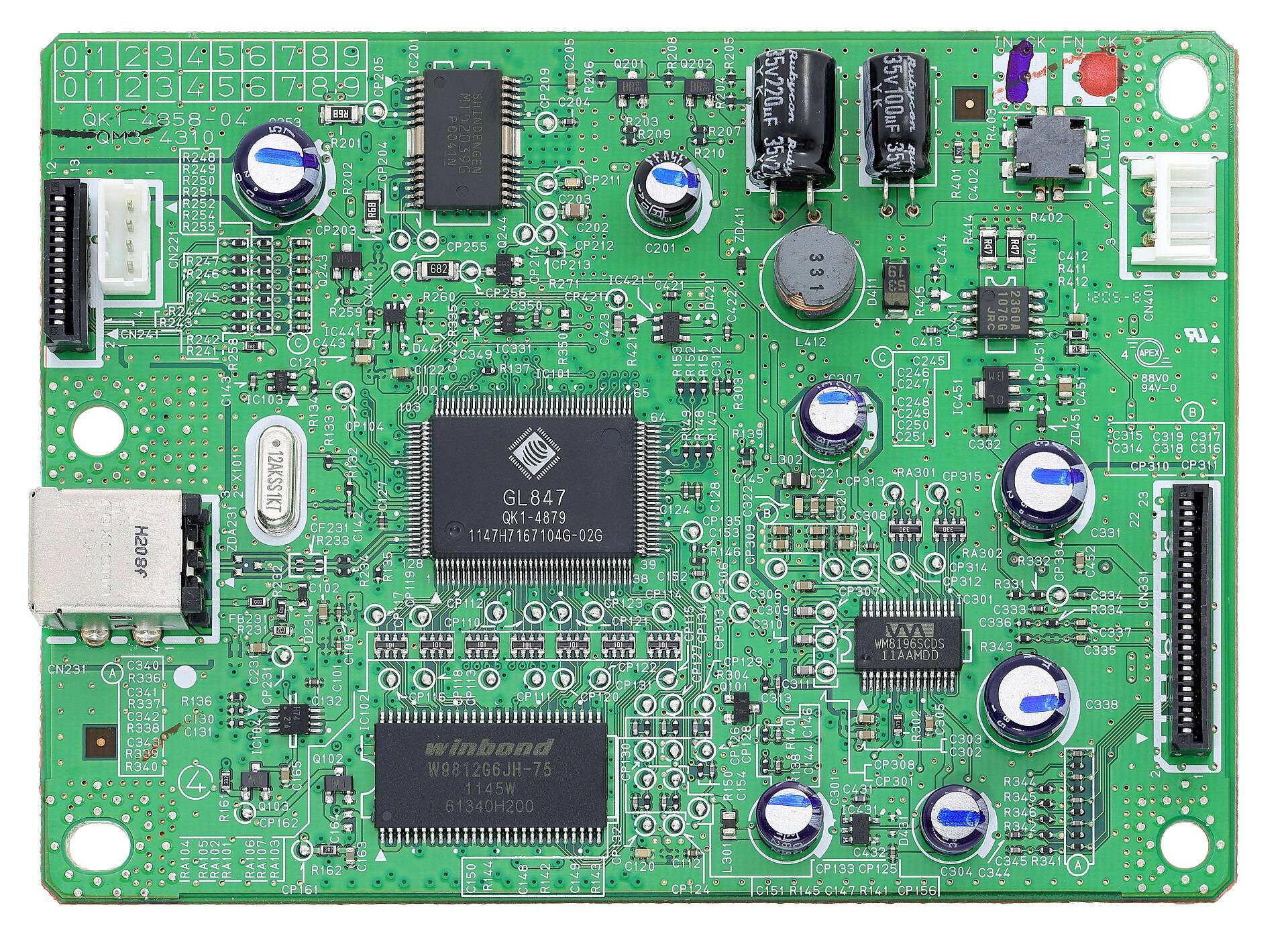 A scanner's circuit board seen flat from above, chips and capacitors in rows