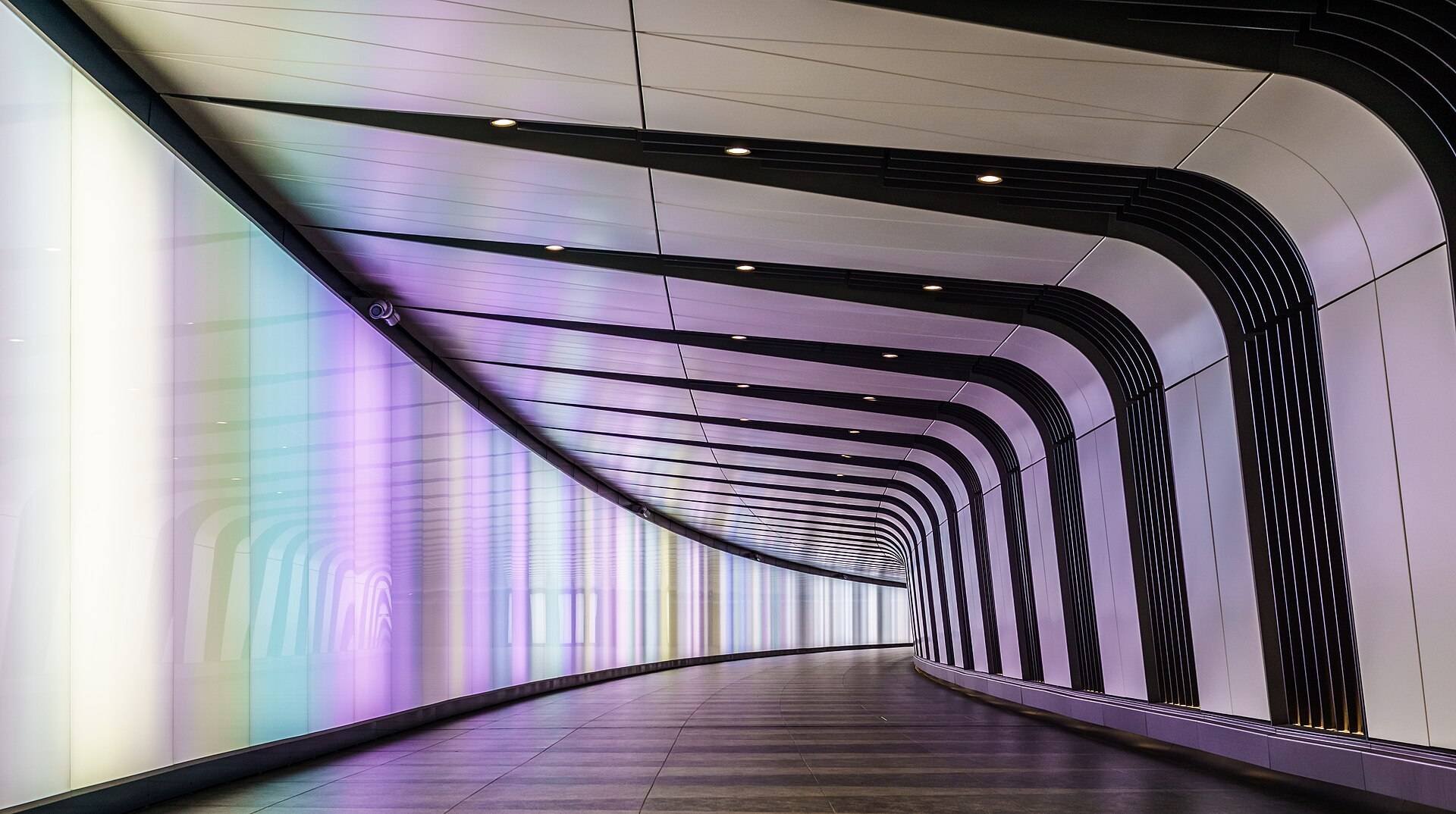 Sample frame: a curved white tunnel lit along one wall, empty