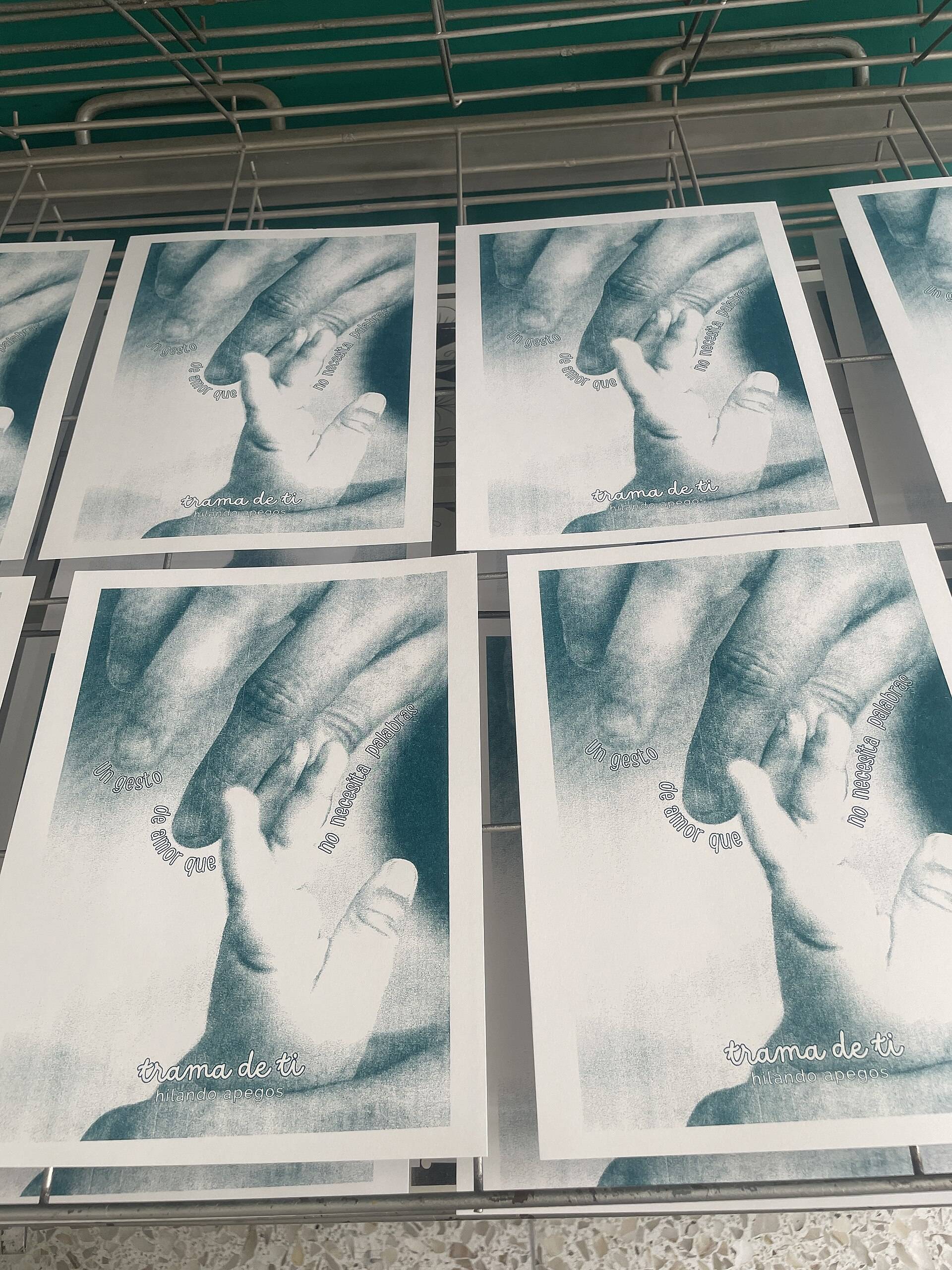 Rows of freshly printed riso posters laid out to dry