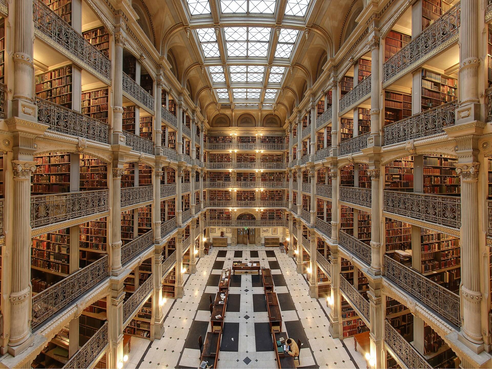 Five tiers of cast-iron book galleries around a long reading floor
