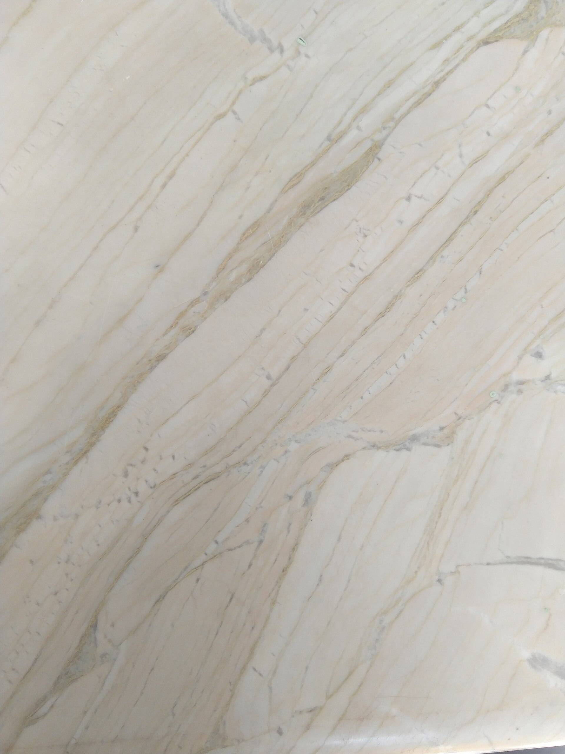 White marble with grey and gold veins running on the diagonal