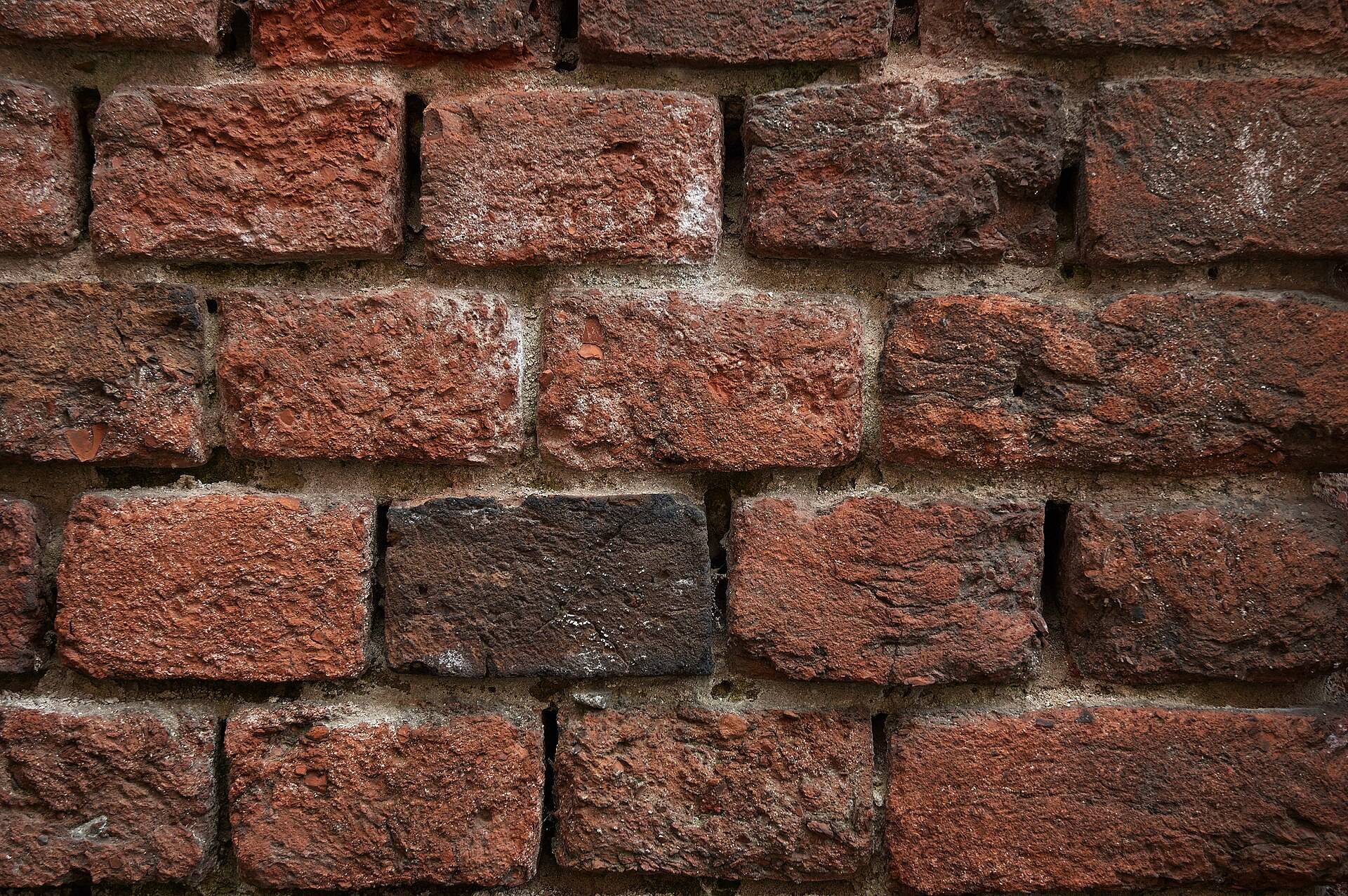 Weathered red bricks laid in thick lime mortar