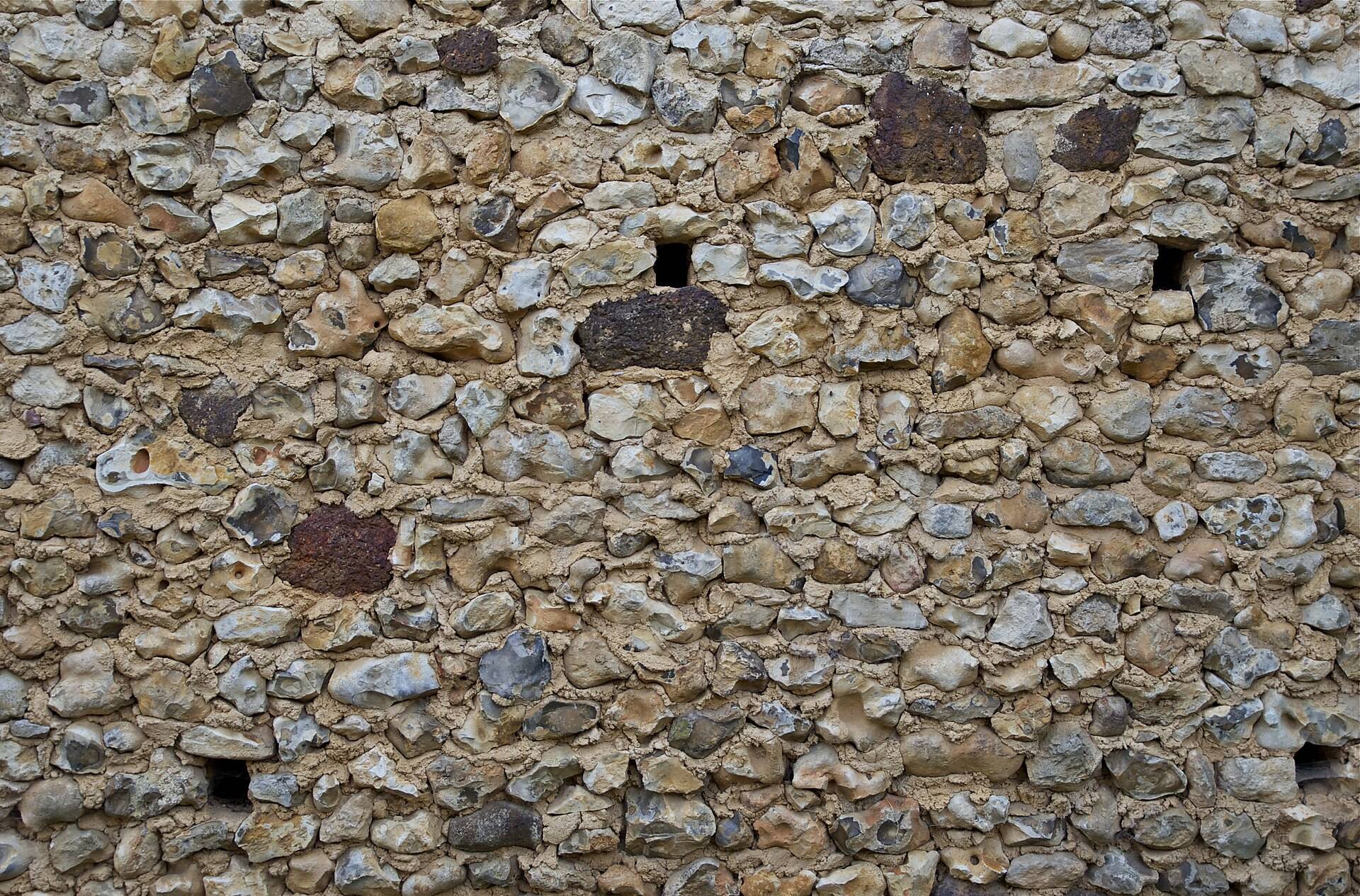 Knapped flint and pale stone cobbles set close in lime